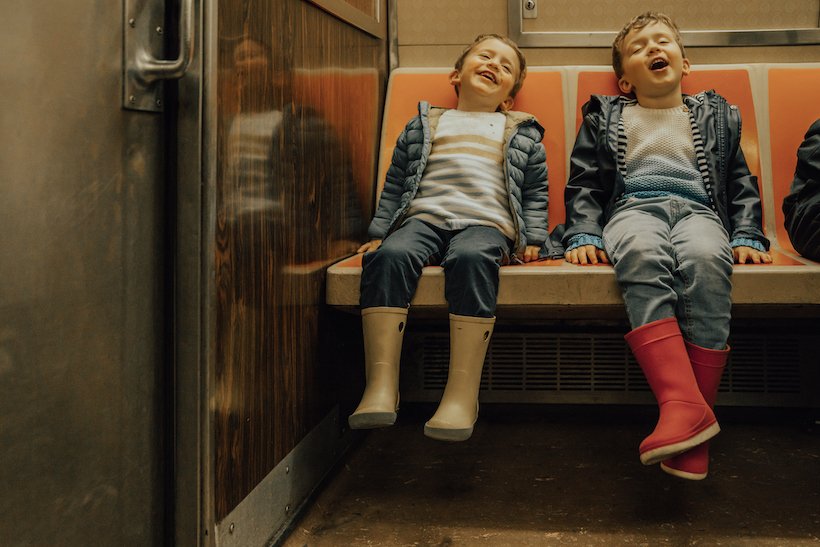 Two children riding on train