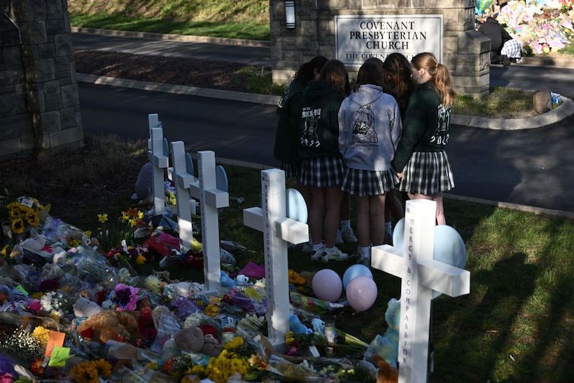 People gather at a makeshift memorial for victims of a shooting at the Covenant School campus, in Nashville, Tennesseet a makeshift memorial for victims of a shooting at the Covenant School campus, in Nashville, Tennessee