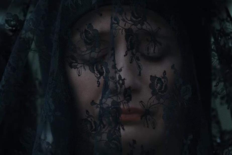 A still from the film, showing Emily Mortimer as Janet Harbinson in a black mourning veil