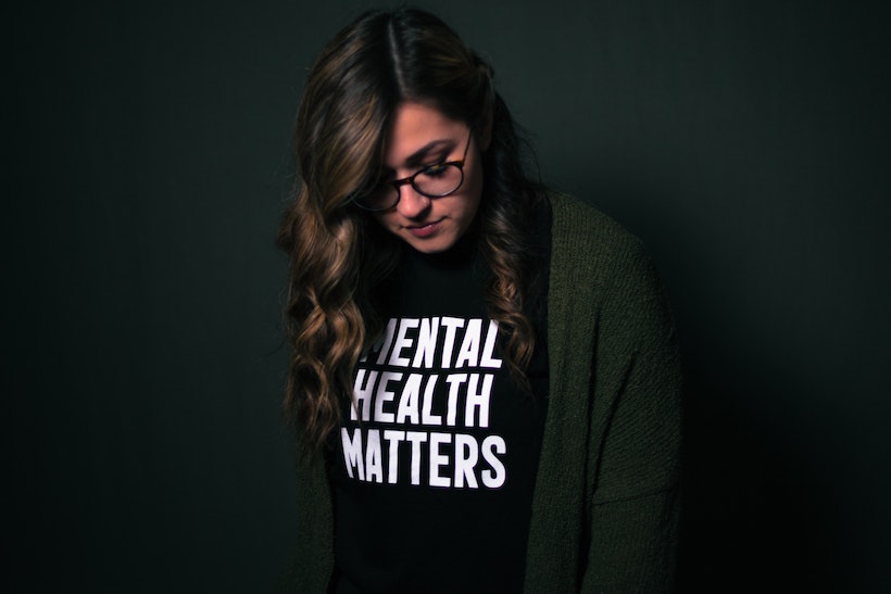 Woman wearing shirt that reads "mental health matters"